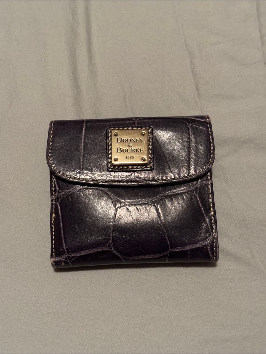 A Dooney & Bourke Croc-Embossed Compact Wallet With Gold Plaque